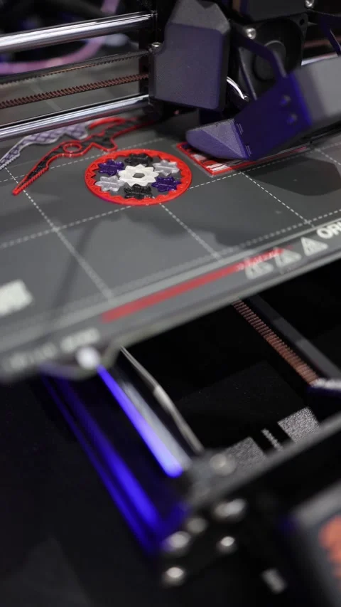 Vertical screen close-up of 3D printer in action creating colorful gear design w Stock Footage 311130416
