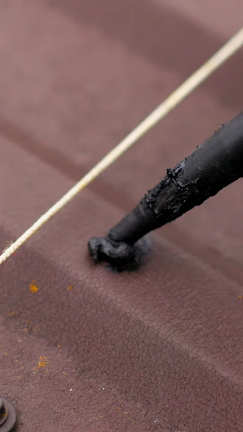 Vertical Screen: Close up of applying sealant on the roof. Carpenter repairing Stock-Footage 272171673