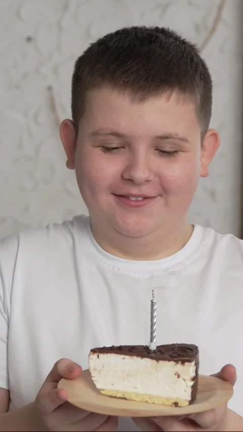 Vertical screen: Close-up of charming caucasian little boy making wish and Stock Footage 263146560