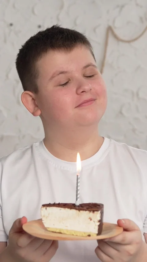 Vertical screen: Close-up of charming caucasian little boy making wish and Stock Footage 263237710