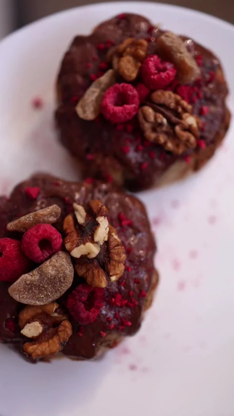 Vertical screen: Close-up of chocolate desserts topped with walnuts, dried rasp) Stock Footage 305295298