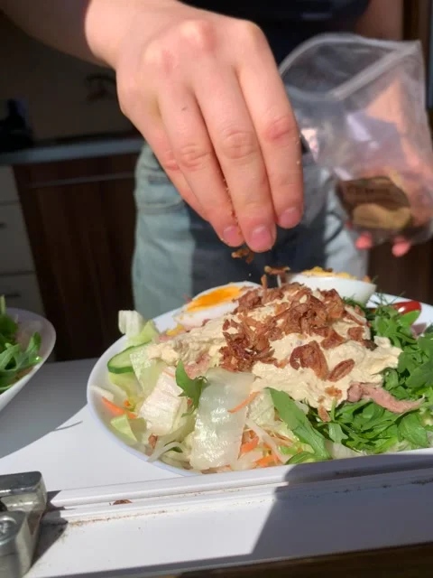 Vertical screen close up of fresh salad preparation with arugula eggs tomatoes h Stock Footage 317086520