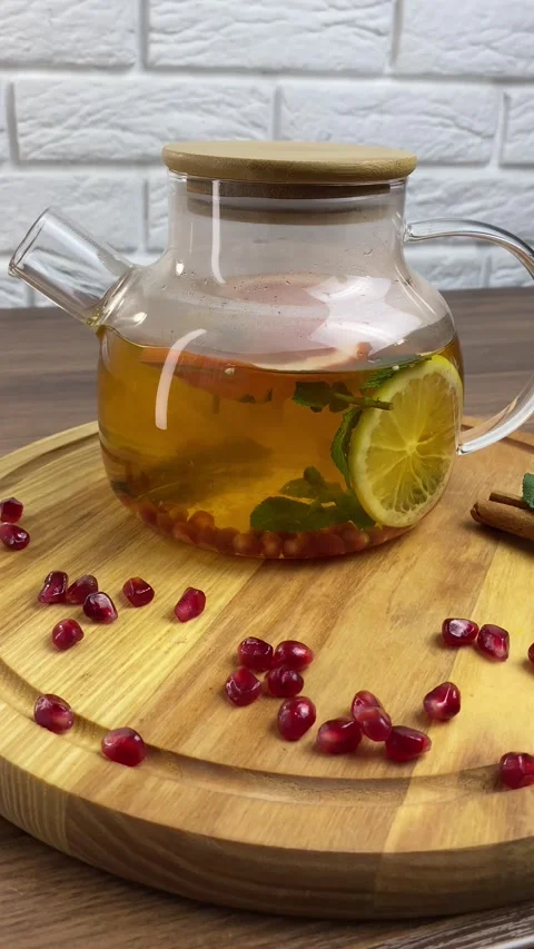 Vertical screen: Close up glass teapot with herbal tea and berries inside. Fresh Stock Footage 265900539