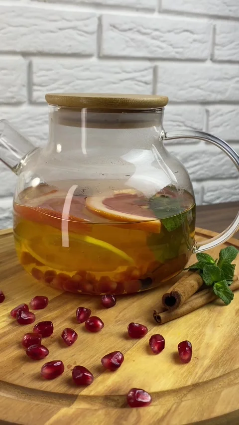Vertical screen: Close up glass teapot with herbal tea and berries inside. Fresh Stock Footage 266149532