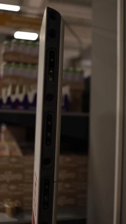 Vertical screen: A close-up of a price-scanning robot in a supermarket, showing  Stock Footage 303850504