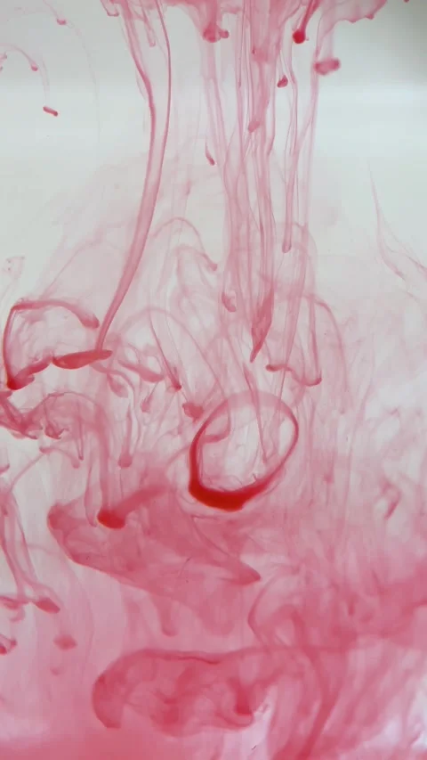 Vertical screen: Close-up shot. Red gouache clouds in water and move in slow Stock Footage 236754943