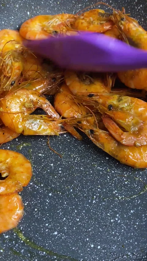 Vertical screen: Close-up of shrimps being fried in oil pan Stock Footage 237706234