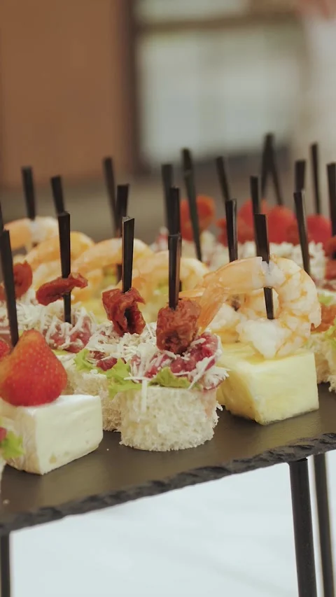 Vertical screen: Close-up of skewer canapes on the buffet table in the wedding Stock Footage 308396099