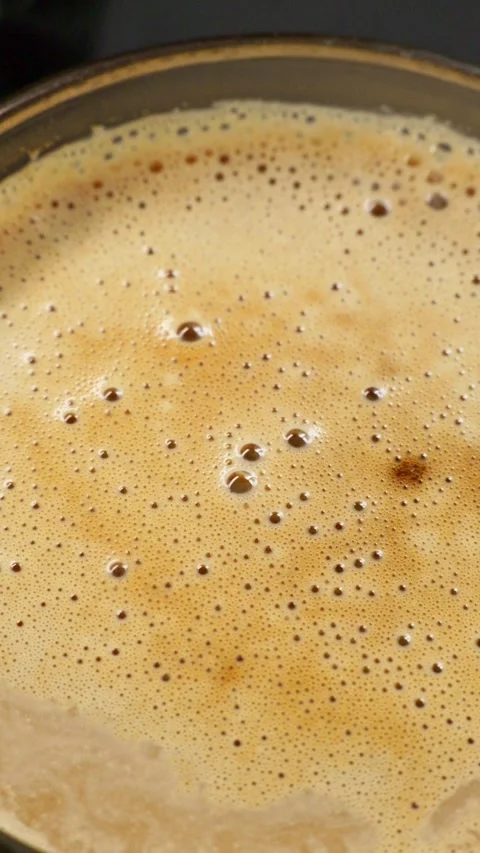 Vertical screen close-up of undisturbed half-dissipated coffee foam. Stock Footage 334161088