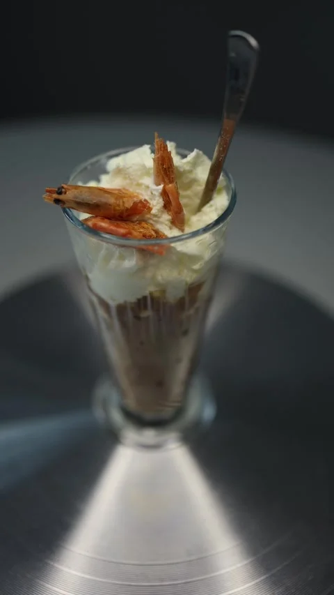Vertical screen A close-up of a unique dessert served in a tall glass with whipp Stock Footage 300021289