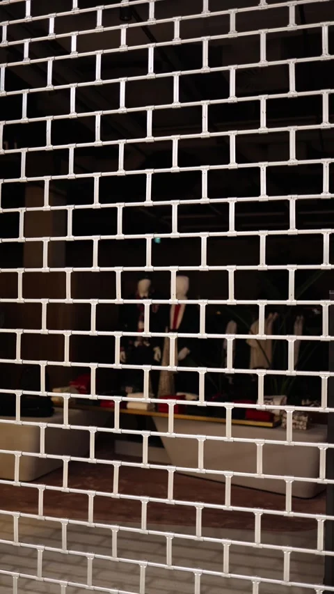 Vertical screen closed shop behind metal shutter in shopping mall at night Stock Footage 323265813