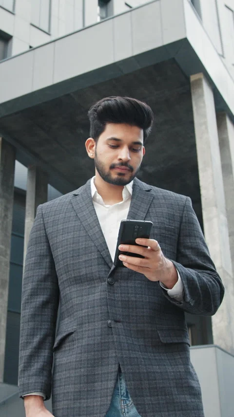 Vertical Screen: CloseUp of Attractive Young Businessman using Smartphone and Stock Footage 272686233