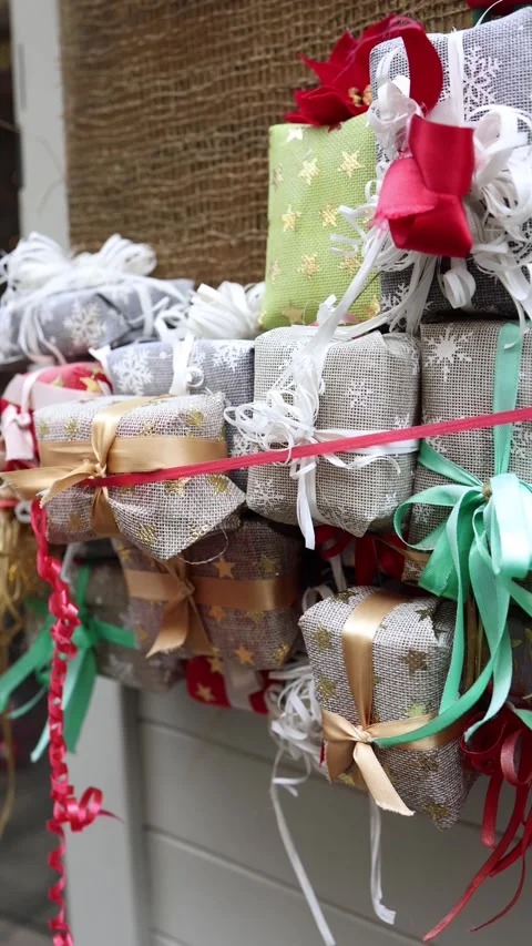 Vertical screen closeup of decorative Christmas gifts wrapped in festive paper w Stock Footage 318869285