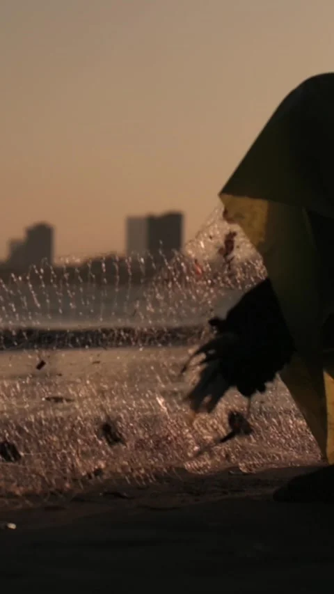 Vertical screen Closeup Shimmering Net Against Sunrise In Da Nang, Asian Fisher Stock Footage 334664403