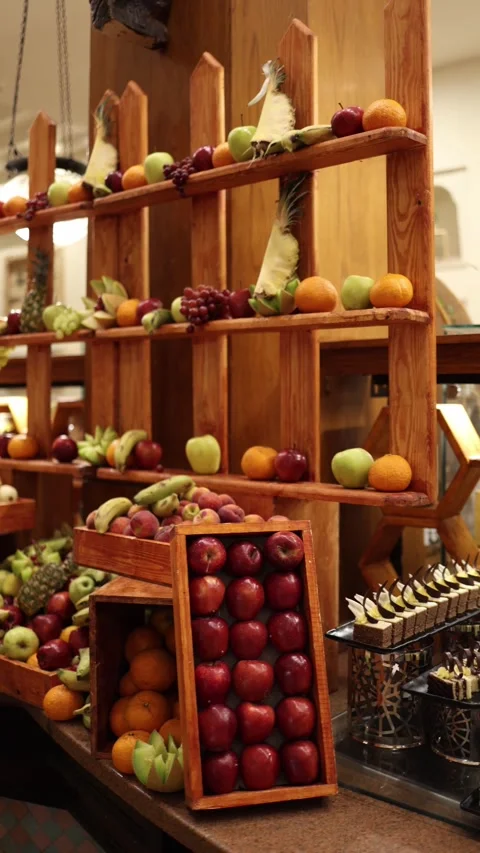 Vertical screen colorful fresh fruit display fills a rustic wooden shelf with gl Stock Footage 310016733