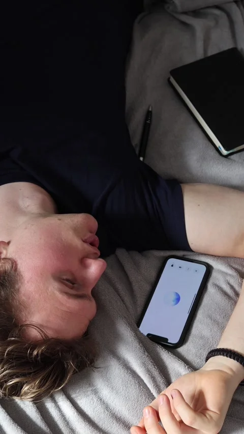Vertical screen communication with artificial intelligence young man lying on be Stock Footage 314979499