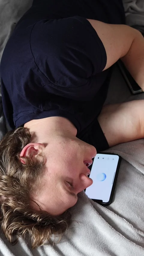 Vertical screen communication with artificial intelligence as student lies on be Stock Footage 314979584