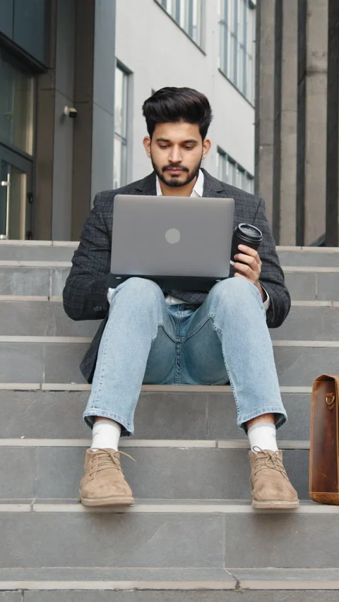 Vertical Screen: Confident hindu man in stylish clothes working on wireless Stock Footage 272832920