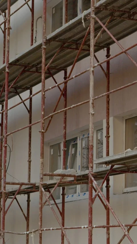 Vertical Screen Construction site showcasing scaffolding for building renovation Stock Footage 303505116