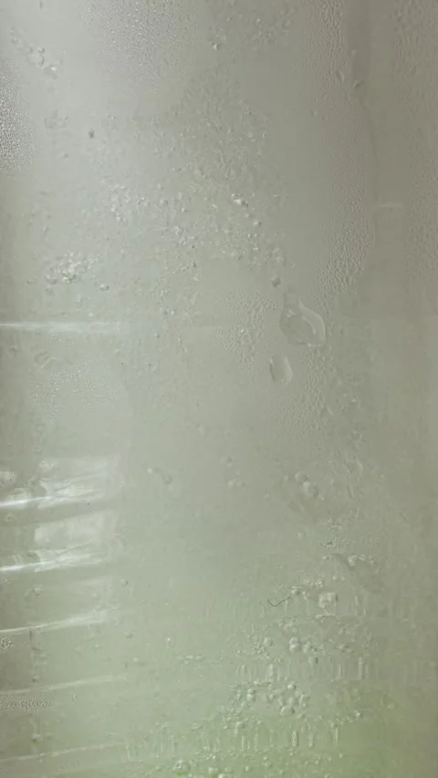 Vertical screen cool refreshing background of ice melting into water in summer. Stock Footage 333542695