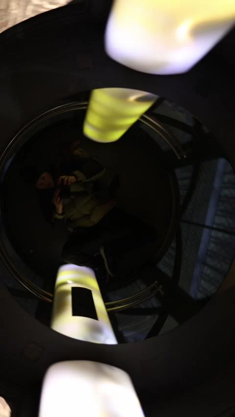 Vertical screen: A creative videographer capturing unique angles inside a modern Stock Footage 296532592