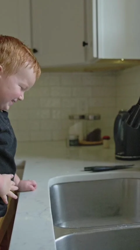 Vertical screen curious kid observes flowing stream, inquisitive youngster Видео 323336204