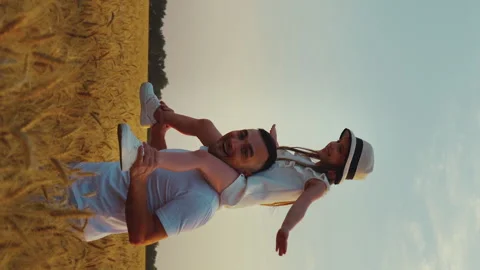 Vertical Screen: Dad playing with daughter in field Stock Footage 166801264