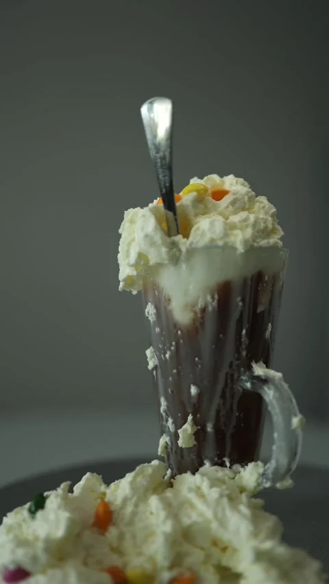 Vertical screen: A decadent mocha topped with overflowing whipped cream and colo Stock Footage 300021500