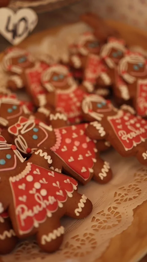 Vertical screen decorated gingerbread cookies shaped like little girls in red dr Stock Footage 318869379