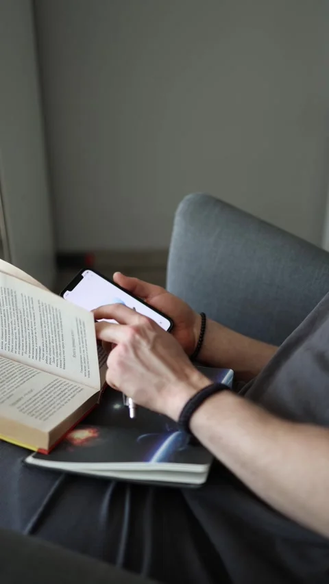 Vertical screen deep focus moment using ChatGPT while studying pen rests on open Stock Footage 305999260