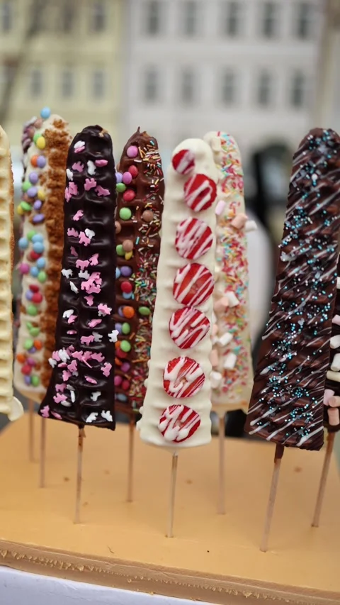 Vertical screen: Delicious chocolate-covered treats with colorful sprinkles and  Stock Footage 303286046