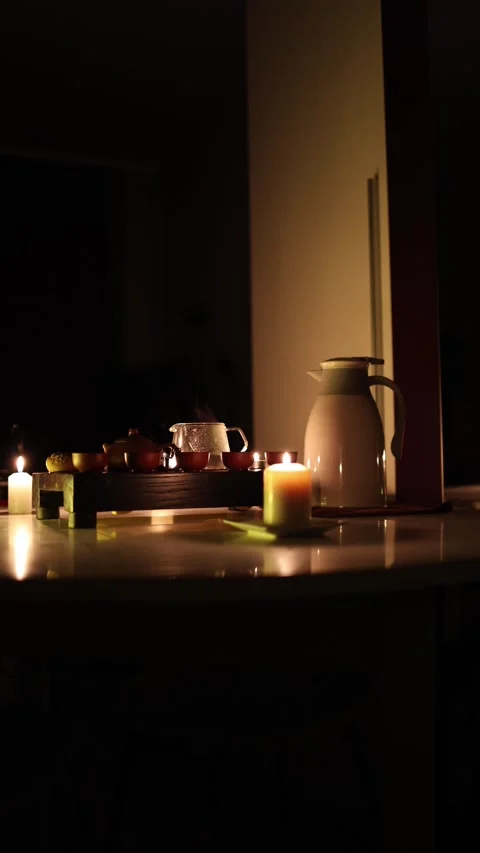 Vertical screen: A dimly lit tea ceremony scene with a wooden tray, clay teapot, Stock Footage 299380281