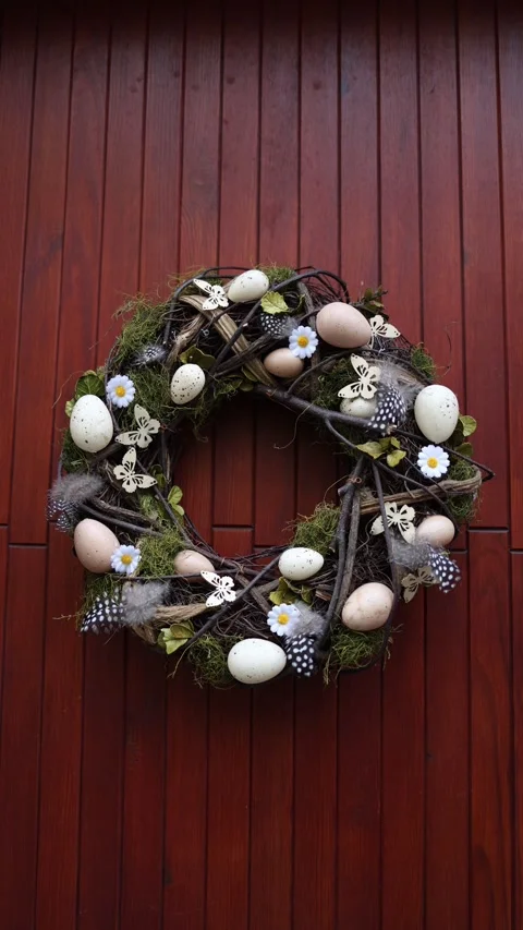 Vertical screen Easter wreath on wooden door made of twigs moss eggs feathers an Stock Footage 306007622