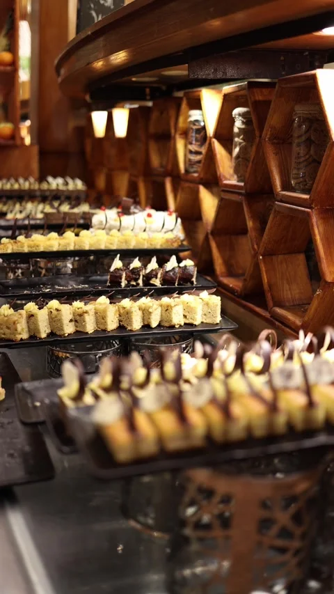 Vertical screen Elegant dessert buffet with layered cakes topped in chocolate cu Stock Footage 310019950