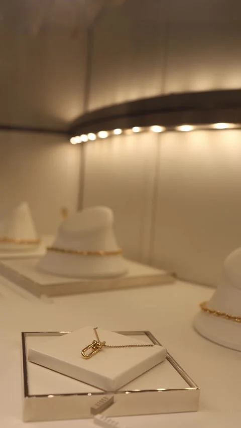 Vertical screen elegant gold necklace with pendant displayed in luxury jewelry s Stock Footage 315414514