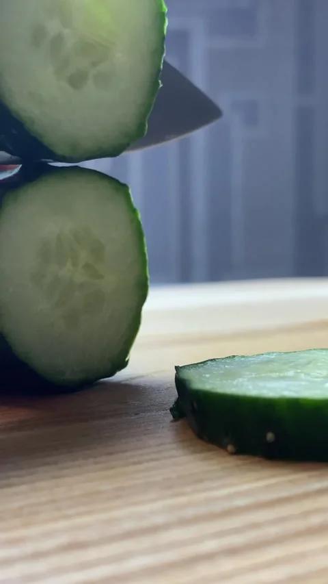 Vertical screen: Extreme close-up of young female housewife cutting green Stock Footage 238770263