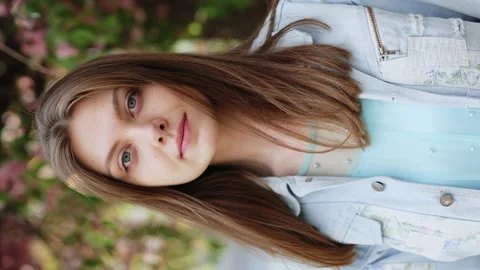 Vertical screen of Face serious young woman looking at camera attractive Stock Footage 194664763