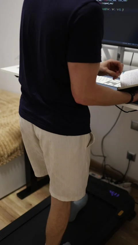 Vertical screen faceless young man studies IT and programming while walking on a Video stock 346881782