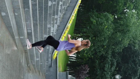 Vertical Screen: Female jogger exercising on staircase in slow motion Stock Footage 249459289