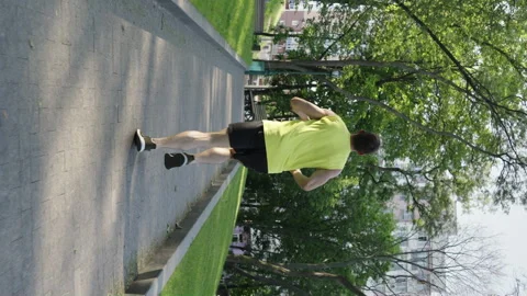 Vertical Screen: Fit man jogging in park in slow motion Stock Footage 247435511