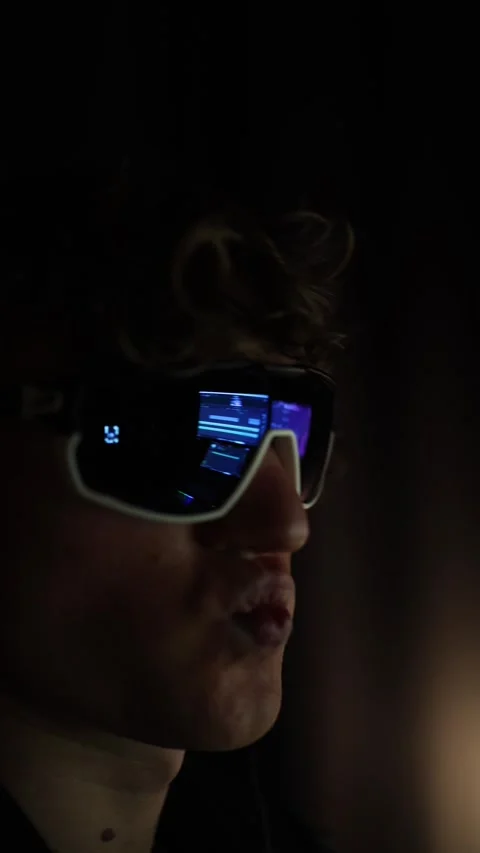 Vertical screen A focused close-up of a person wearing futuristic sunglasses, re Stock Footage 297110706