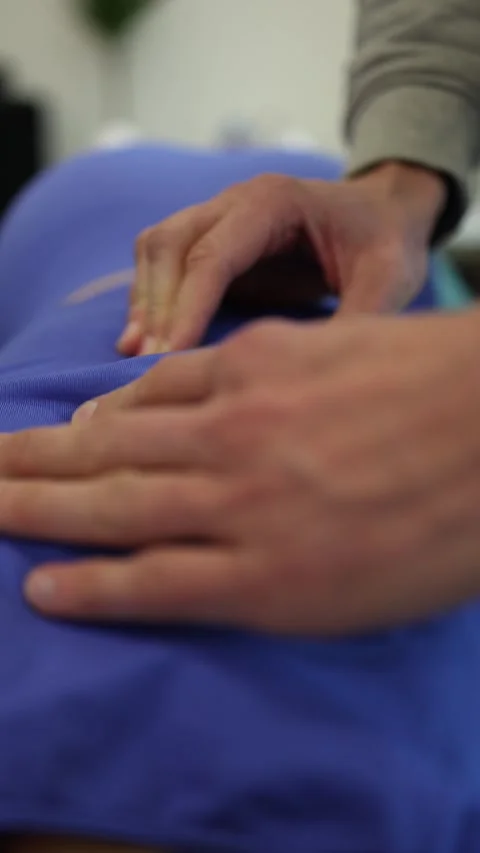 Vertical screen focused hands apply precise finger pressure to back gentle thera Stock Footage 306540674