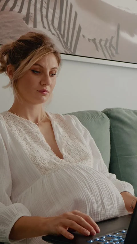 Vertical Screen Freelance while being pregnant using laptop in the living room.. Stock Footage 303495375