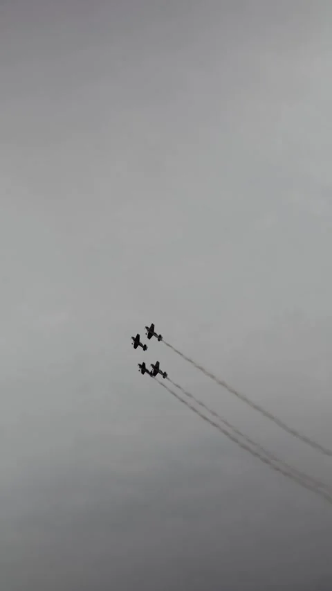 Vertical screen freestyle aerobatic jets race in tight diamond formation through Stock Footage 311150079