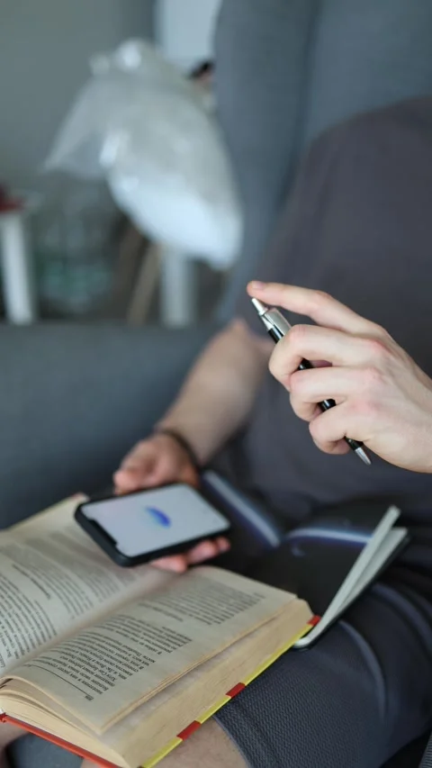 Vertical screen getting ready for exams with ChatGPT flipping pages checking fac Stock Footage 305999247