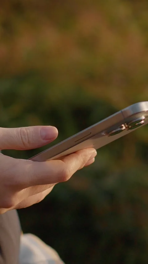Vertical Screen Girl using smartphone in a park Stock Footage 303563607