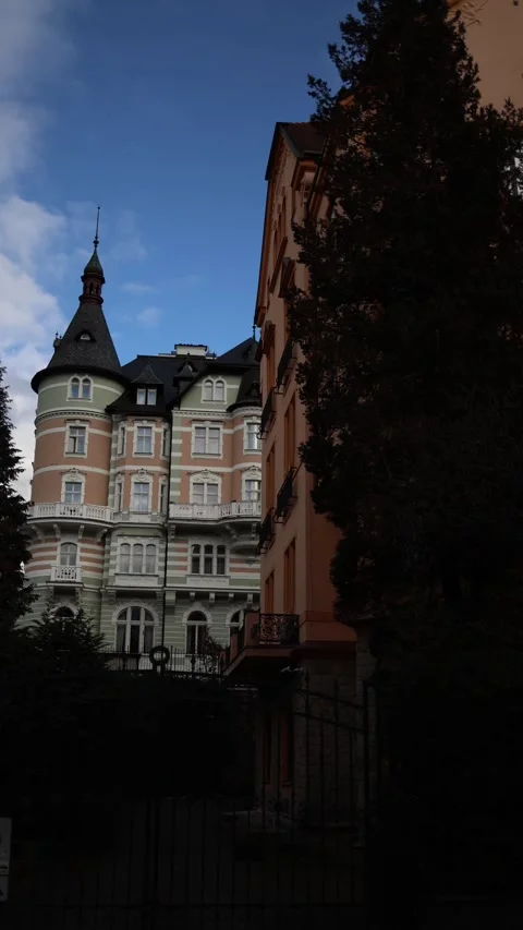 Vertical screen: A grand building with a distinctive green and orange facade, fe Stock Footage 300539806