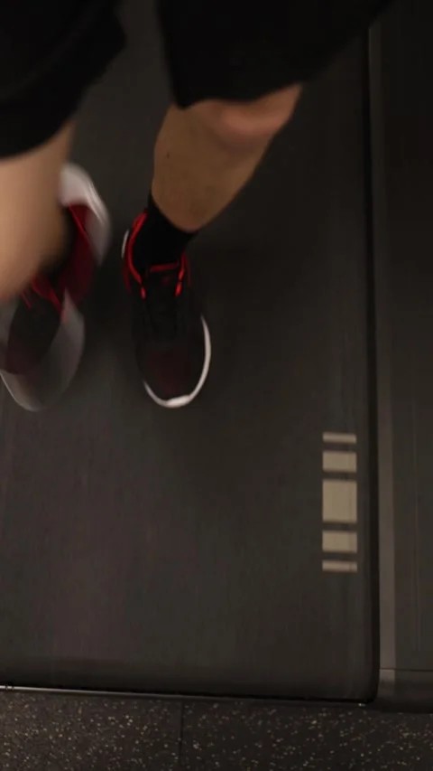 Vertical screen: In the gym, an individual walks on a treadmill as part of their Stock Footage 301677006