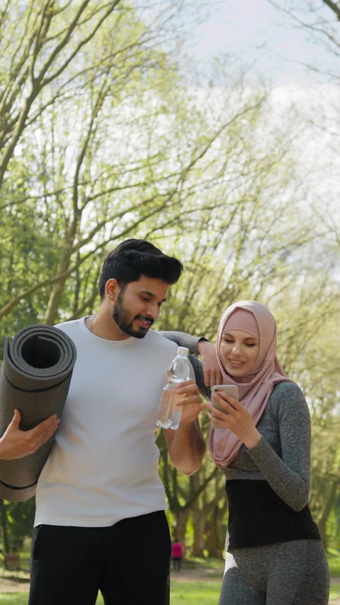 Vertical Screen: Handsome arabian guy with yoga mat and bottle of water looking Stock Footage 274197113