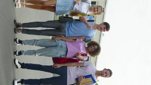 Vertical Screen: Happy students showing thumbs up near college Video stock 248046905